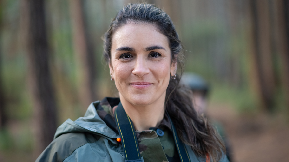 Portrait of attractive woman in forest. Female model with dark hair and ponytail looking at camera. Portrait, beauty concept minimalist habits.
