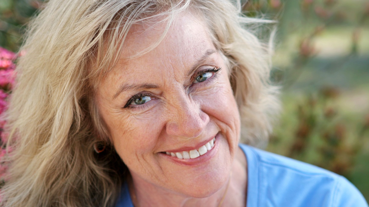 A beautiful mature woman smiling with perfect teeth. Horizontal orientation.