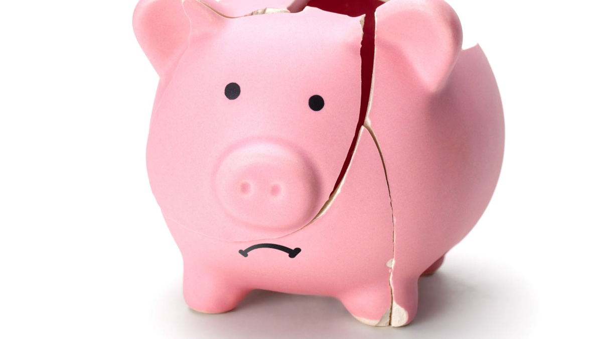 Broken piggy bank isolated on white background.