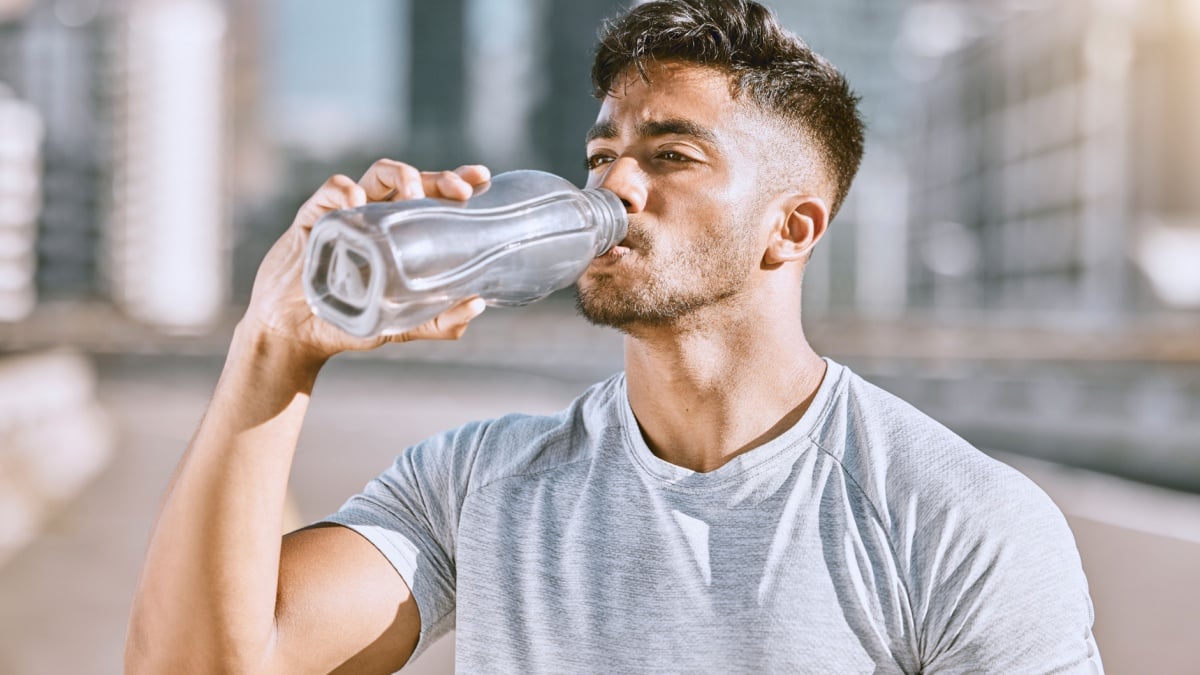 Drinking water, fit and healthy man living an active health, wellness and body or weight watching lifestyle.