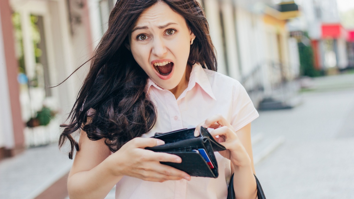 empty wallet - woman with no money . Shopping girl upset crying as she is out of money so she does a no-spend challenge.