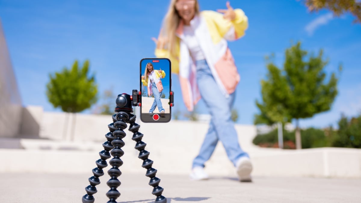 Teenage girl filming video of herself on mobile phone.
