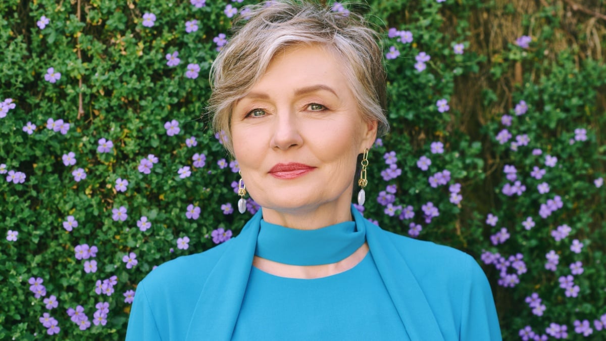 Spring portrait of beautiful mature 55 - 60 year old woman posing outside.