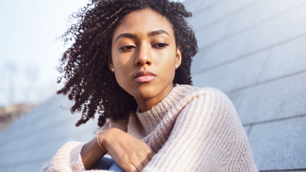 Portrait of black girl suffering solitude and depression.