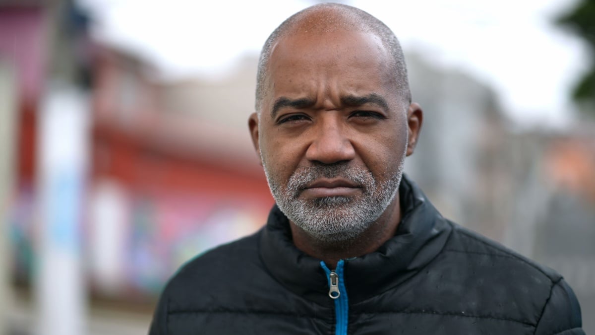 A senior black man portrait face with serious expression looking at camera.