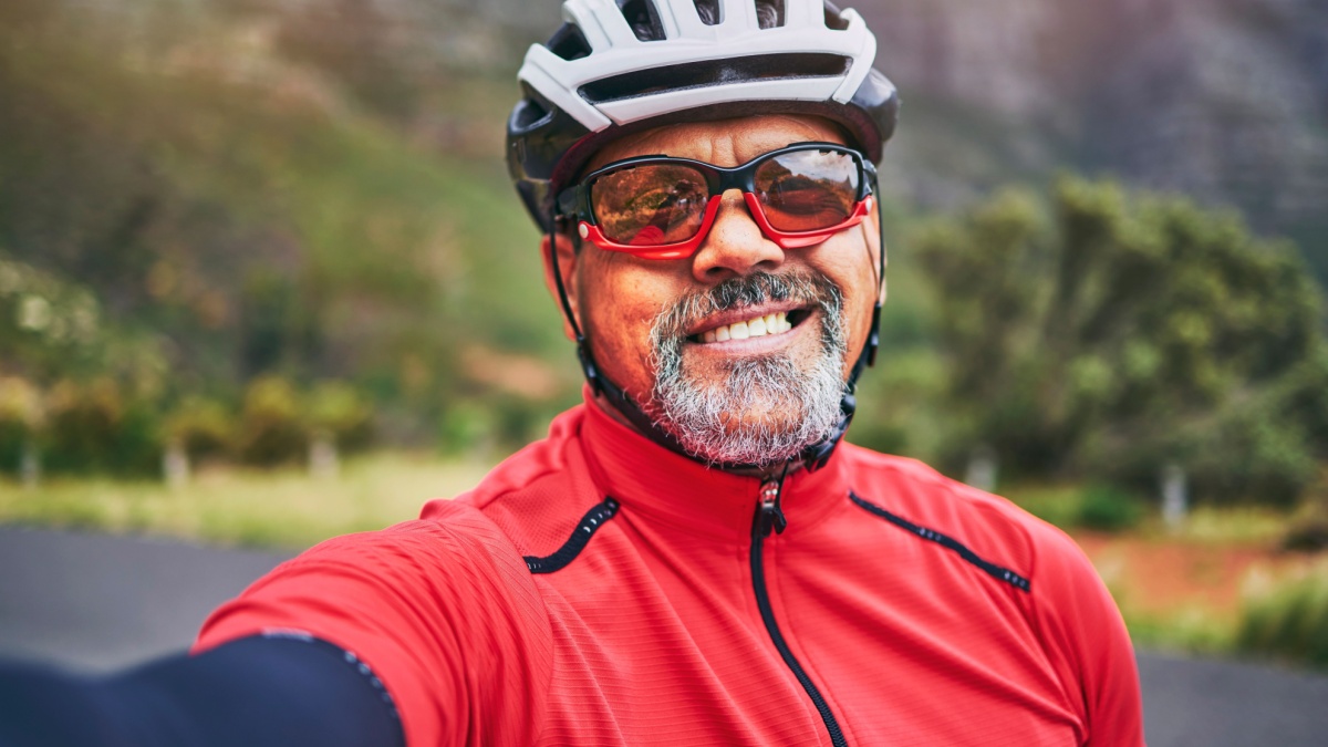 Happy man, cyclist and portrait in selfie on mountain bicycle for photograph, picture or outdoor memory in nature.