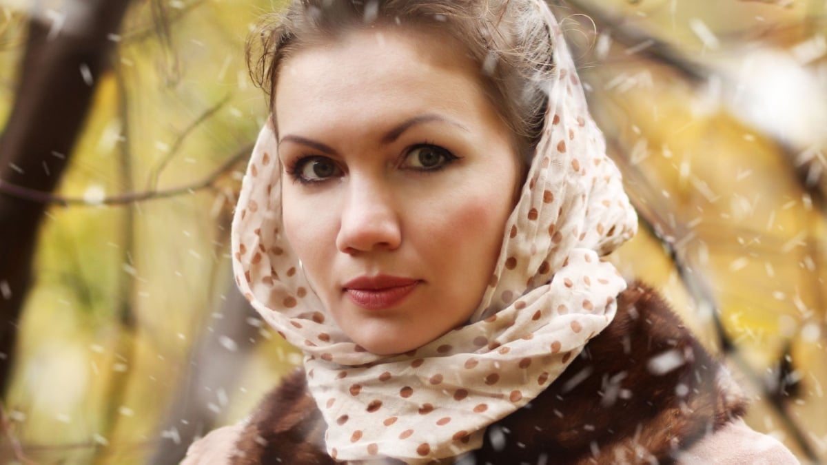 Portrait of young woman in autumn coat. Vintage photo.