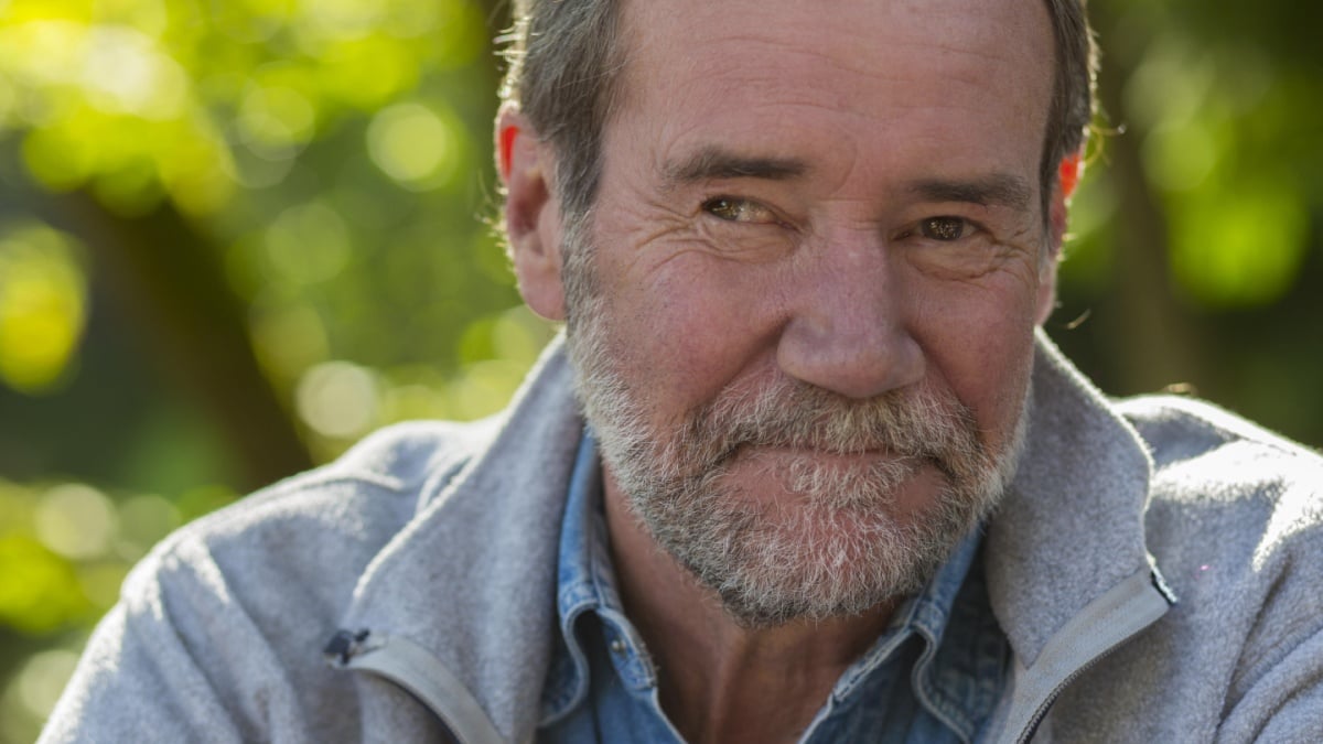 Closeup of an older man outside.