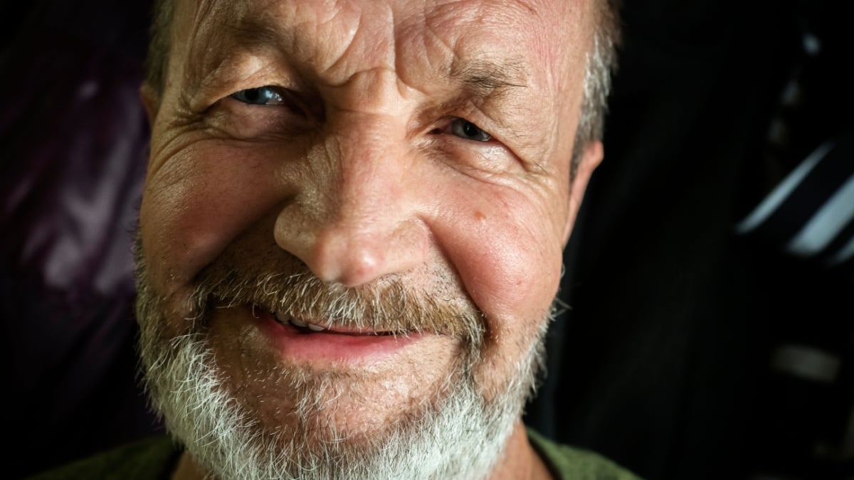Elderly smiling man close-up face.