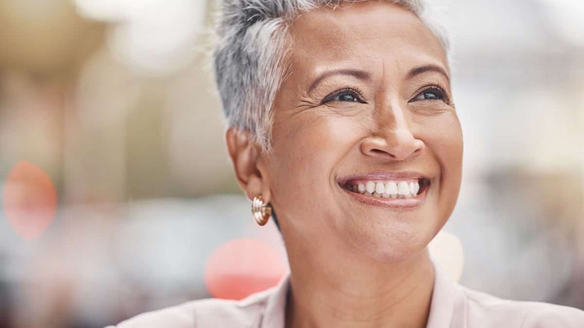 Senior woman smile, city and business person with blurred background thinking of finance work. Urban, investment vision and mature female face outdoor happy about investing and retirement ideas.
