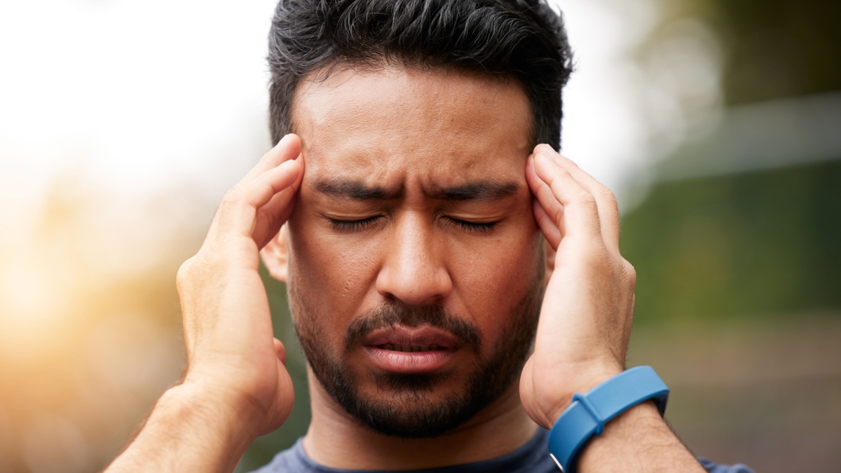 Face of sports man, headache and pain outdoor for injury, vertigo and tired of exercise problem. Sad asian athlete, sick runner and training with migraine, fatigue or stress of burnout for fitness.