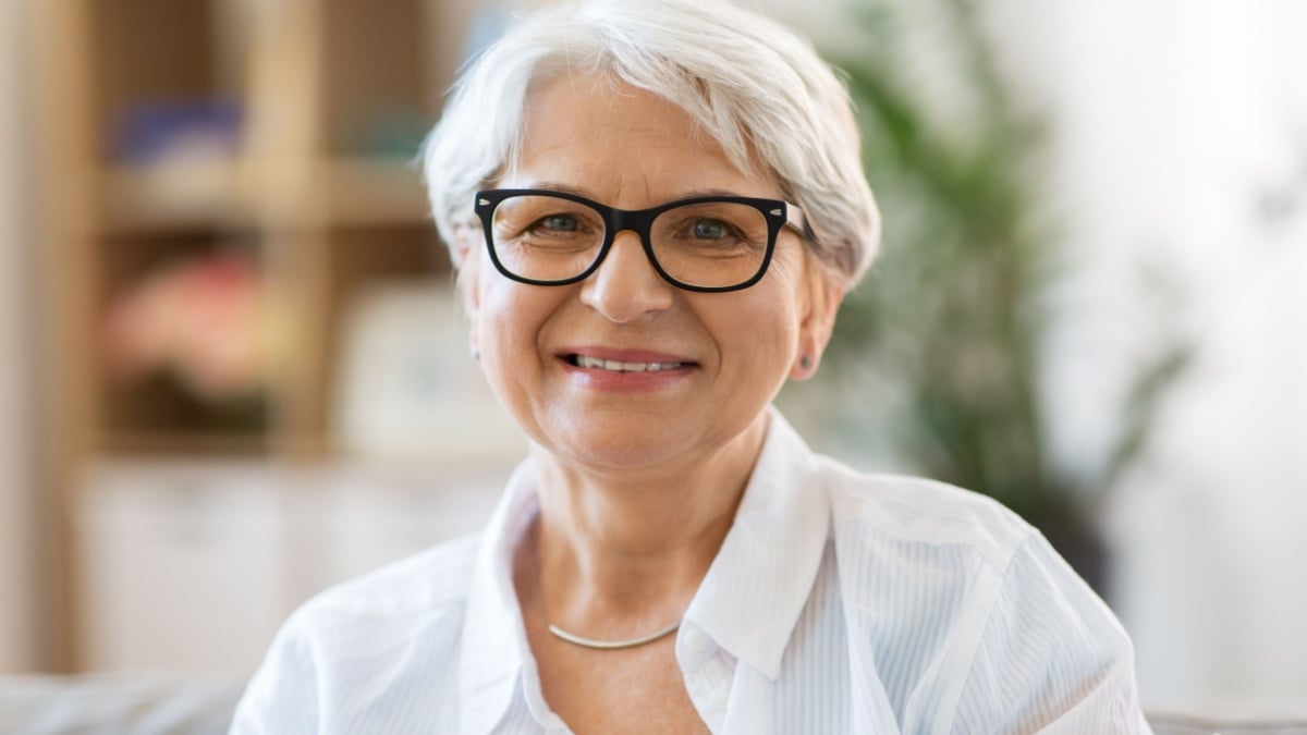 vision, age and people concept - portrait of happy senior woman in glasses.