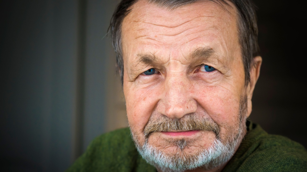 Sad pensive elderly man with mustache close-up portrait.
