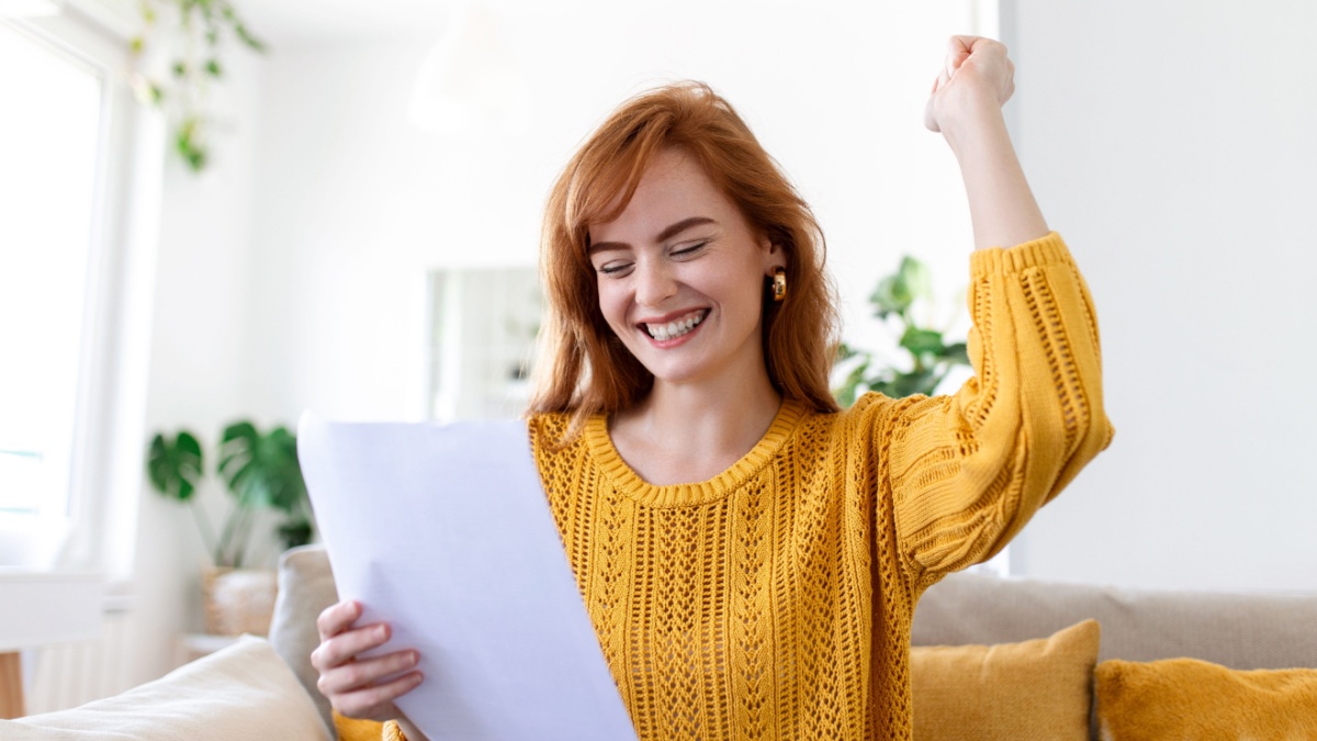 Excited young woman hold paper letter feel euphoric receiving job promotion or tax refund from bank, happy woman reading paperwork document smiling of good pleasant news, getting student scholarship.