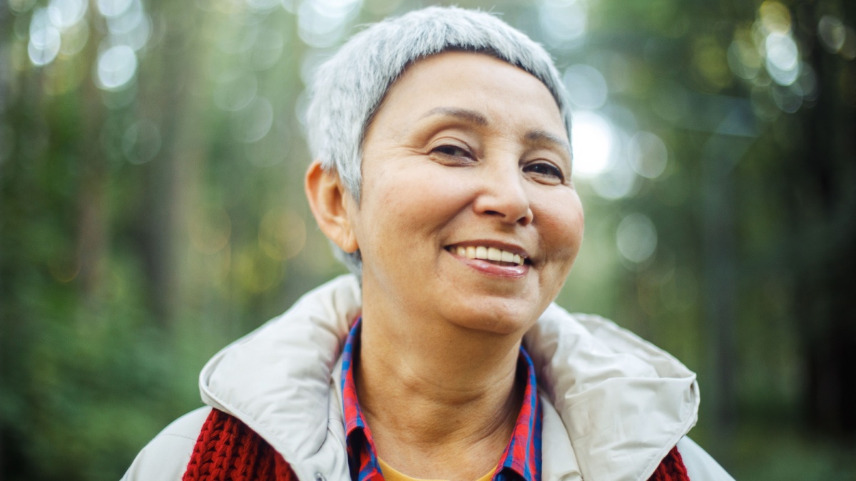 Portrait of elderly Asian woman with short gray hair in the park..