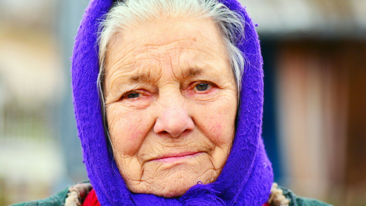 Portrait of old woman in blue kerchief.