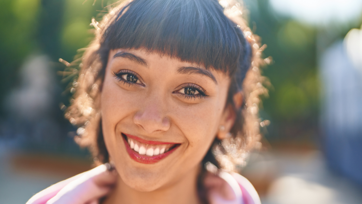 Young woman smiling confident standing at park.