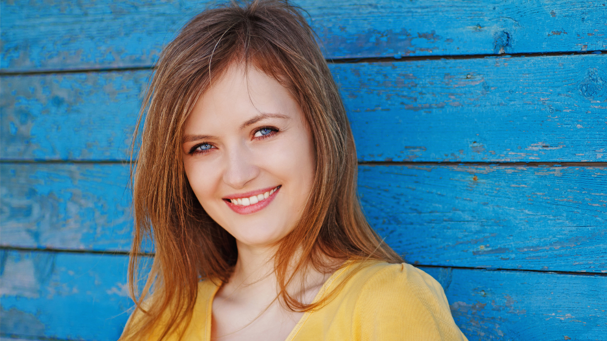 beautiful blonde on the background of old blue wall.