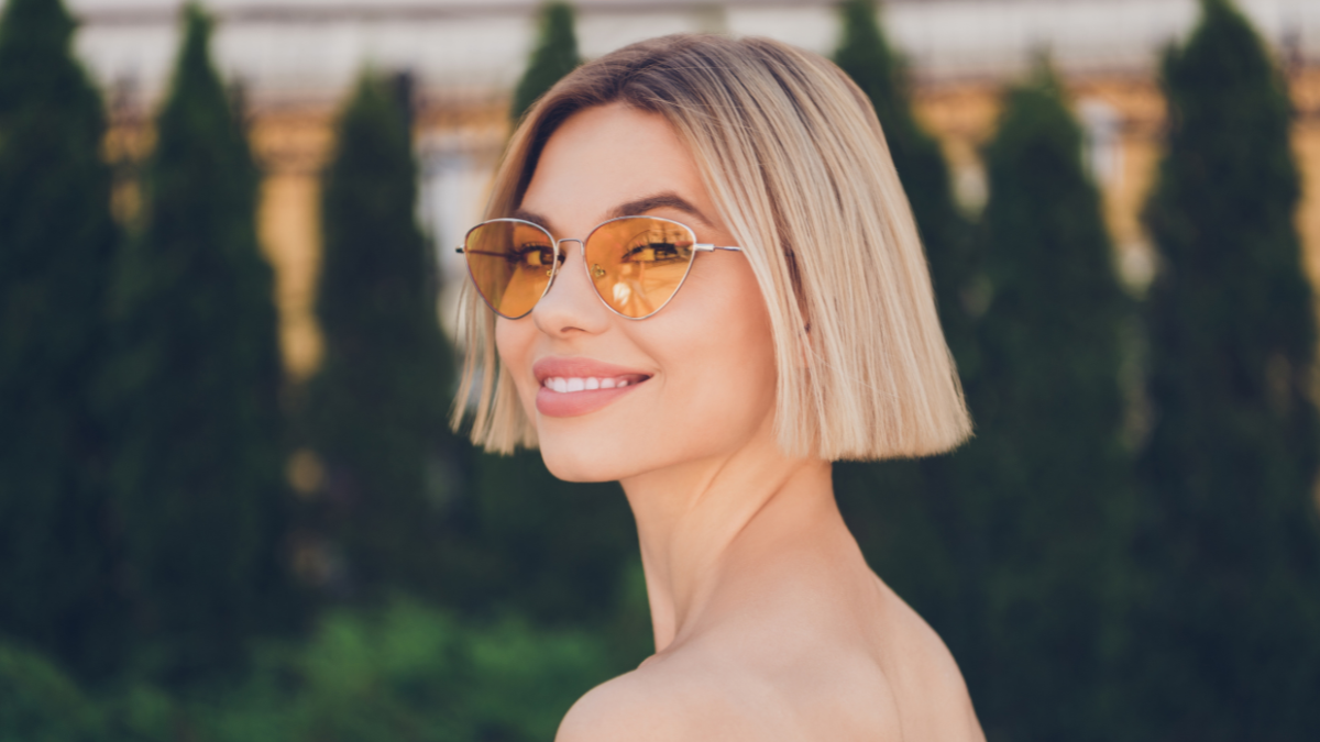 Profile side photo of young attractive girl happy positive smile wear sunglass summer nature outdoors.