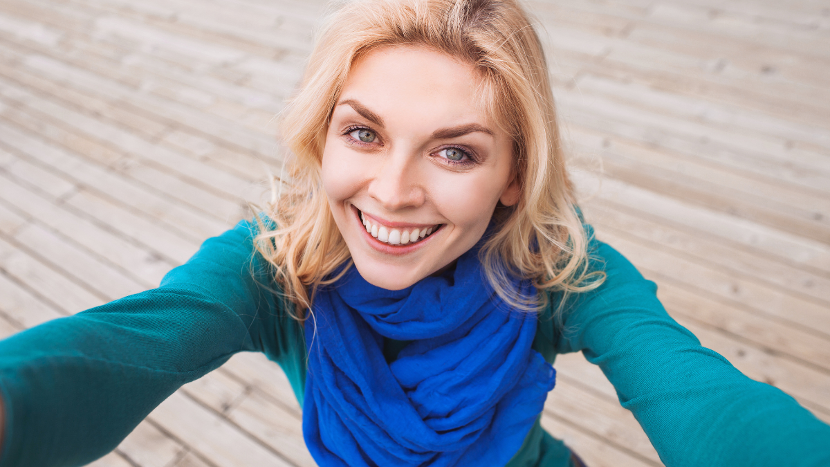 Pretty young woman taking self portrait selfie photo.