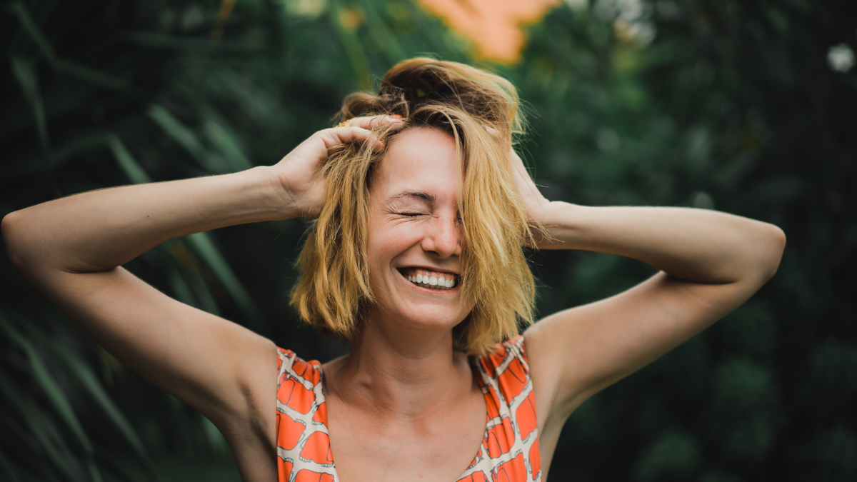 young beautiful blonde girl against the tropical palm trees. beautiful girl with an attractive smile and glowing eyes. emotional portrait of fashion portrait of pretty young hipster blonde. woman.
