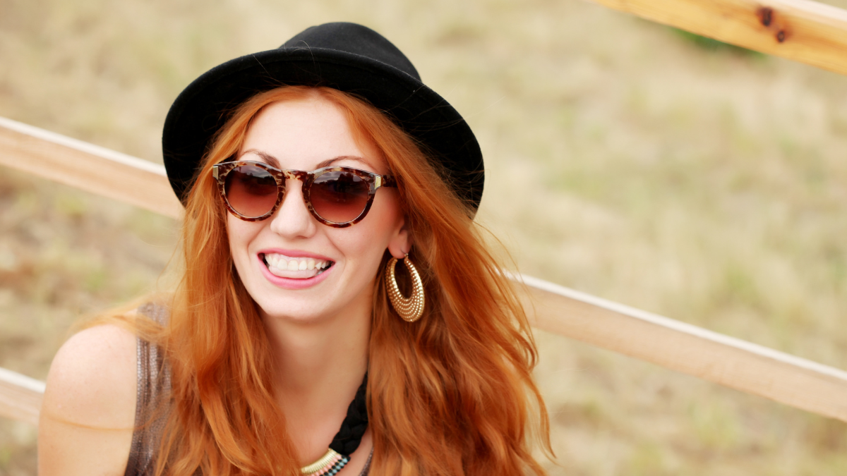 Cool hipster student woman wearing eyewear glasses. Fashion funny glamor stylish sexy smiling beautiful young woman model in summer clothes walking in the street.