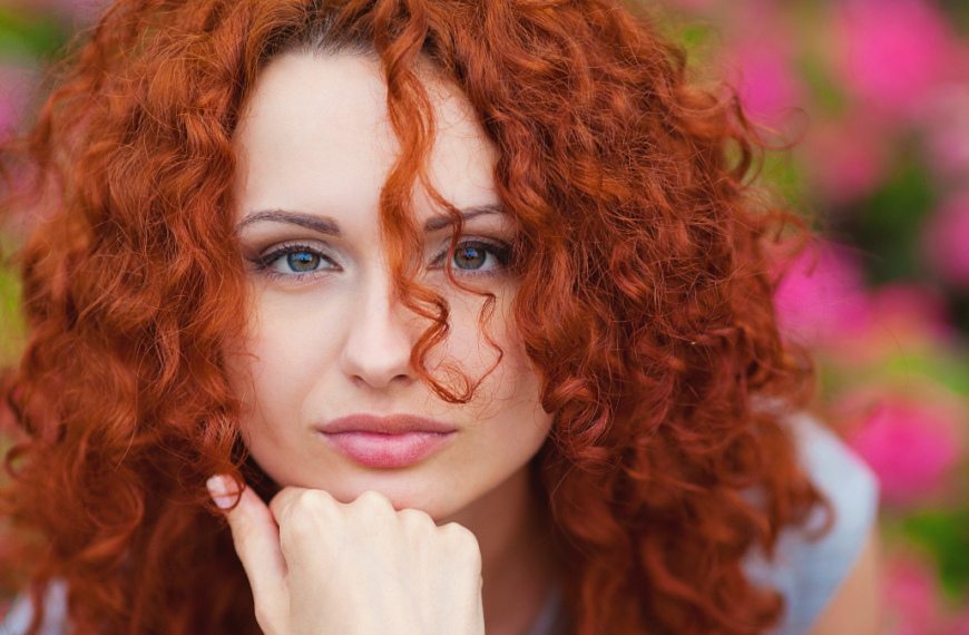 portrait of cute red haired young woman, outdoor.