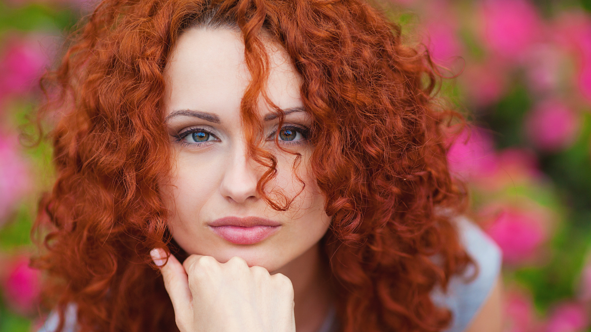 portrait of cute red haired young woman, outdoor.