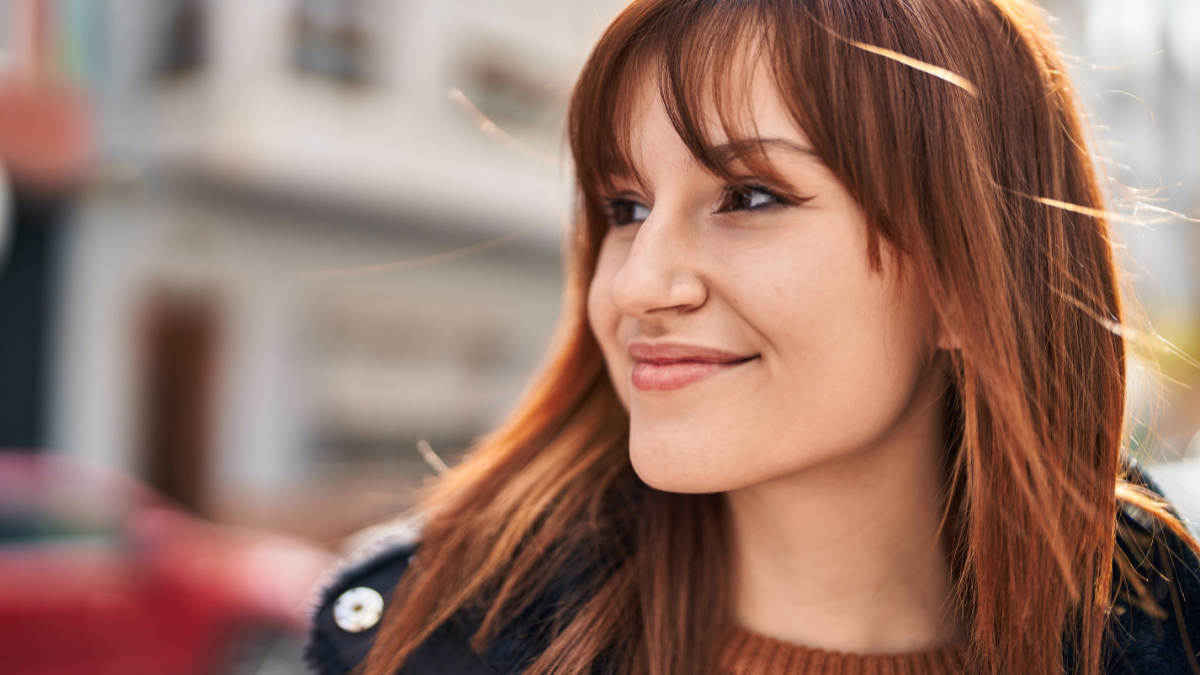 Young woman smiling confident standing at street.