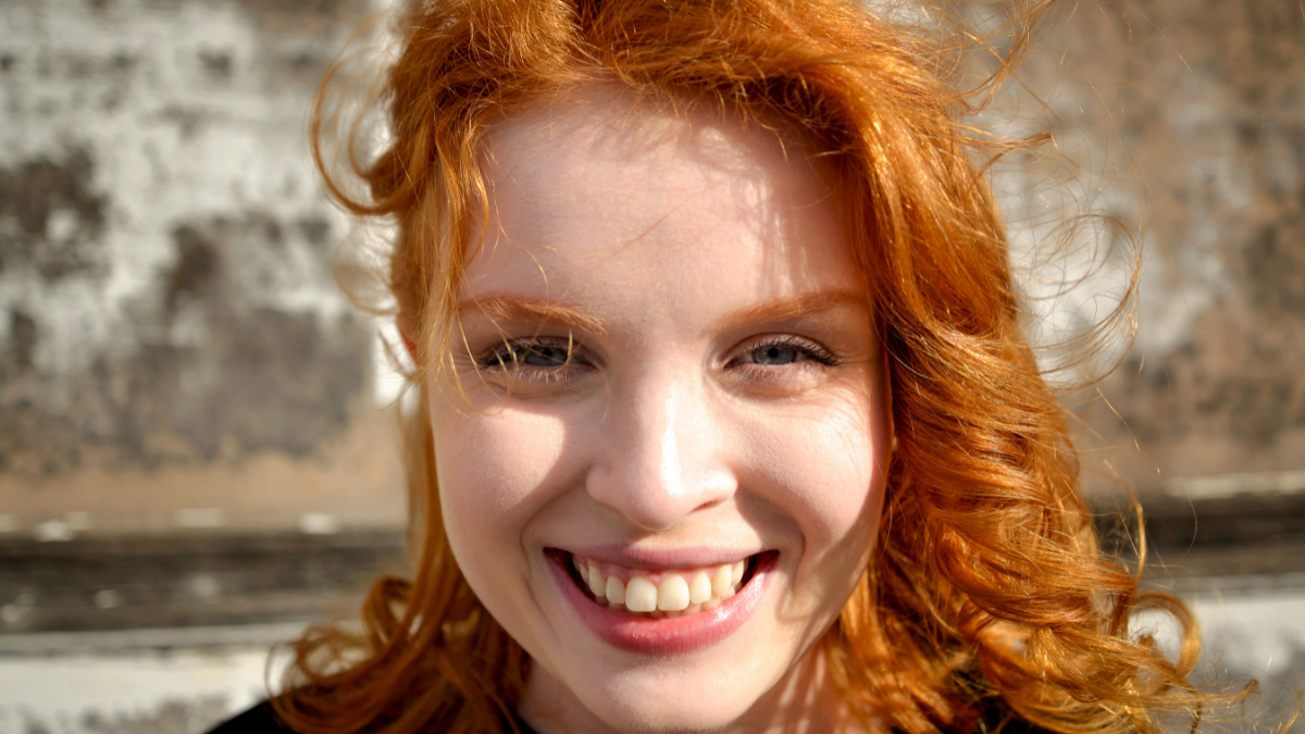 Portrait of a beautiful happy red headed woman.