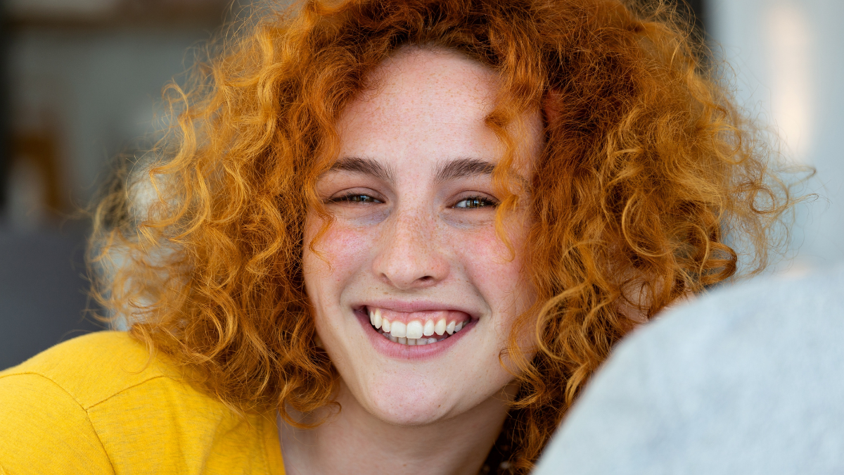 Portrait of a beautiful woman smiling at home. woman in casual looking at camera with copy space. Cheerful woman relaxing at home with smile.