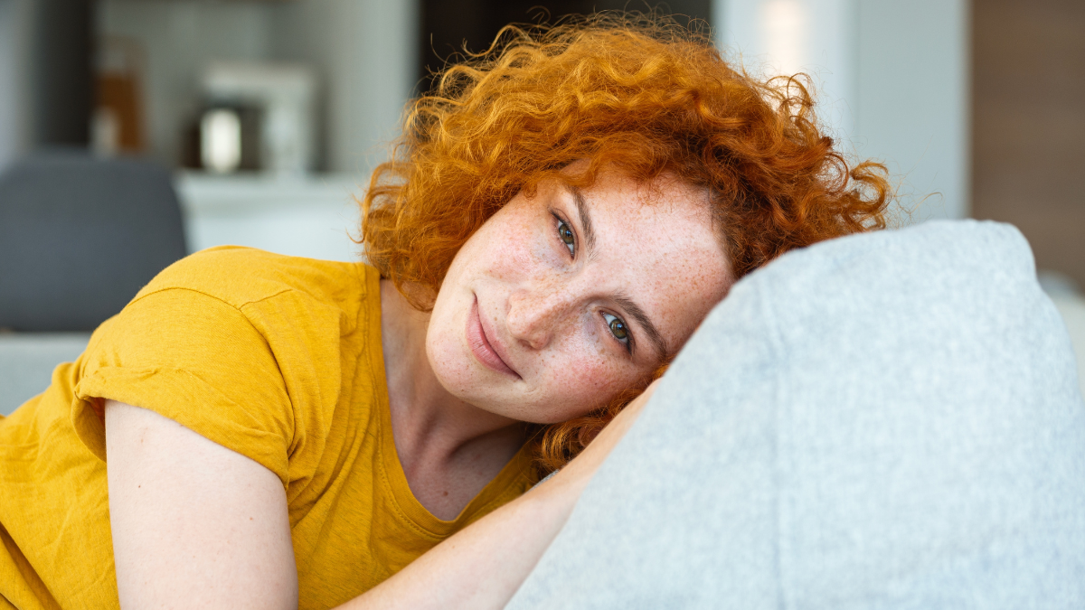 Portrait of a beautiful woman smiling at home. woman in casual looking at camera with copy space. Cheerful woman relaxing at home with smile.