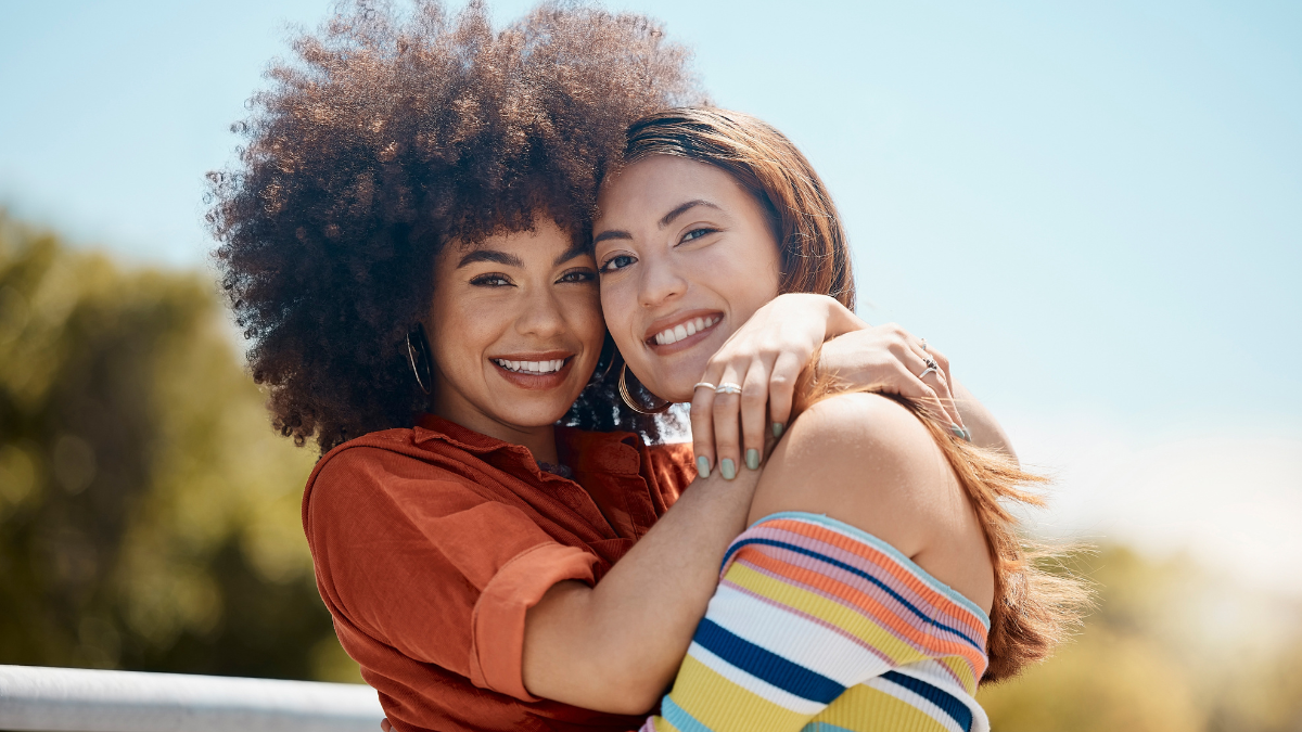 happy people hugging outside.