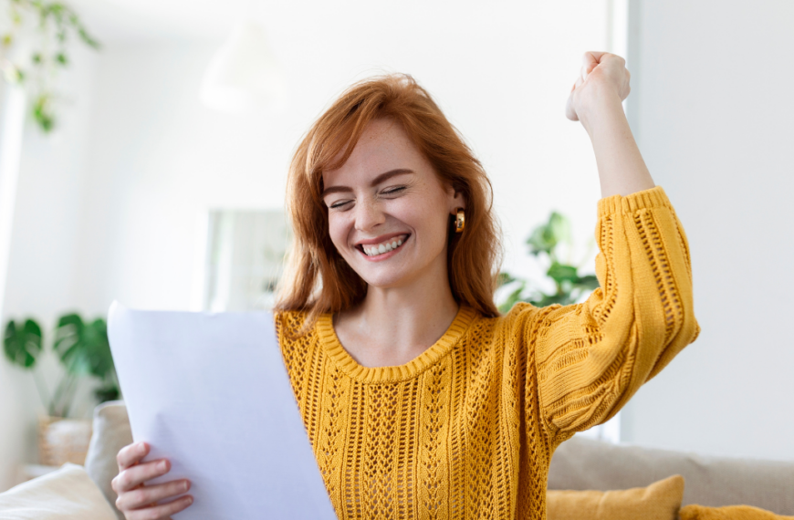 Excited young woman hold paper letter feel euphoric receiving job promotion or tax refund from bank, happy woman reading paperwork document smiling of good pleasant news, getting student scholarship.