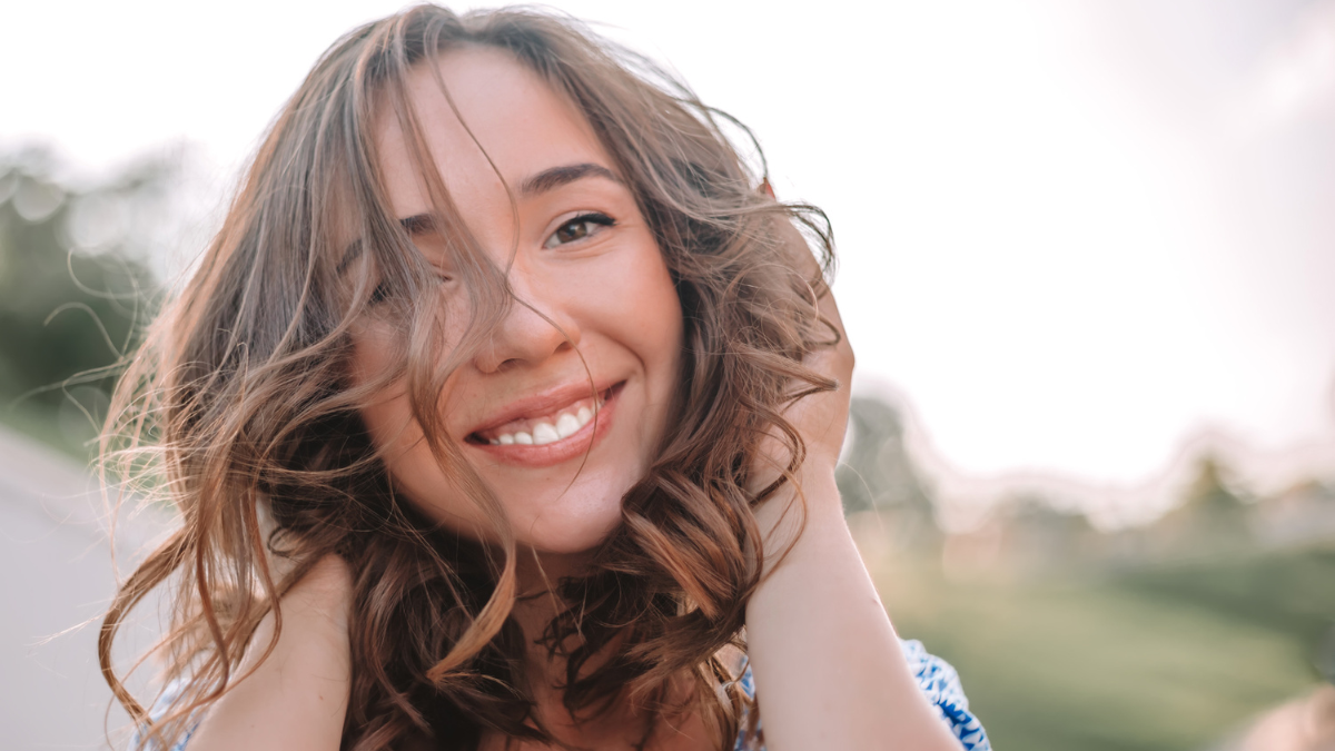 Close-up portrait of beautiful caucasian woman with charming smile walking outdoors.Close up morning portrait of smiling pretty woman with green eyes, sensual fresh happy face, positive emotions.