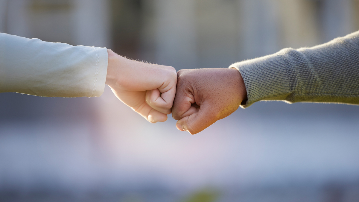 Motivation, support and people with a fist bump for partnership, goal and teamwork. Thank you, community and friends with a hand gesture for collaboration, connection and solidarity in the city.