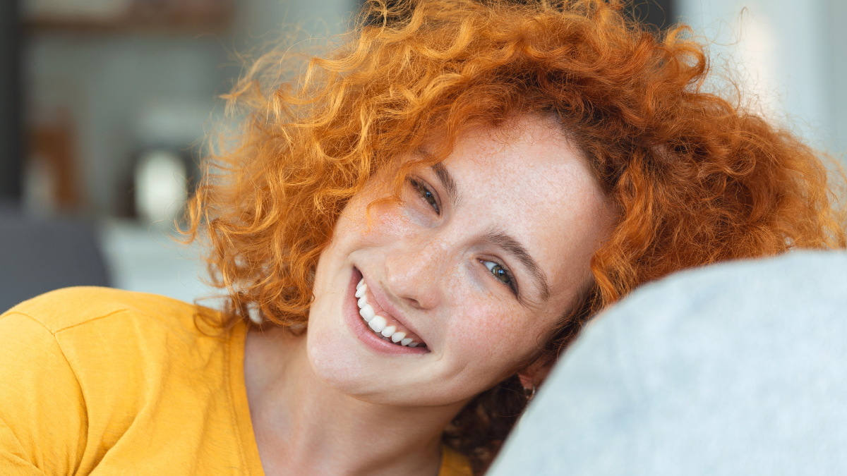 Portrait of a beautiful woman smiling at home. woman in casual looking at camera with copy space. Cheerful woman relaxing at home with smile.
