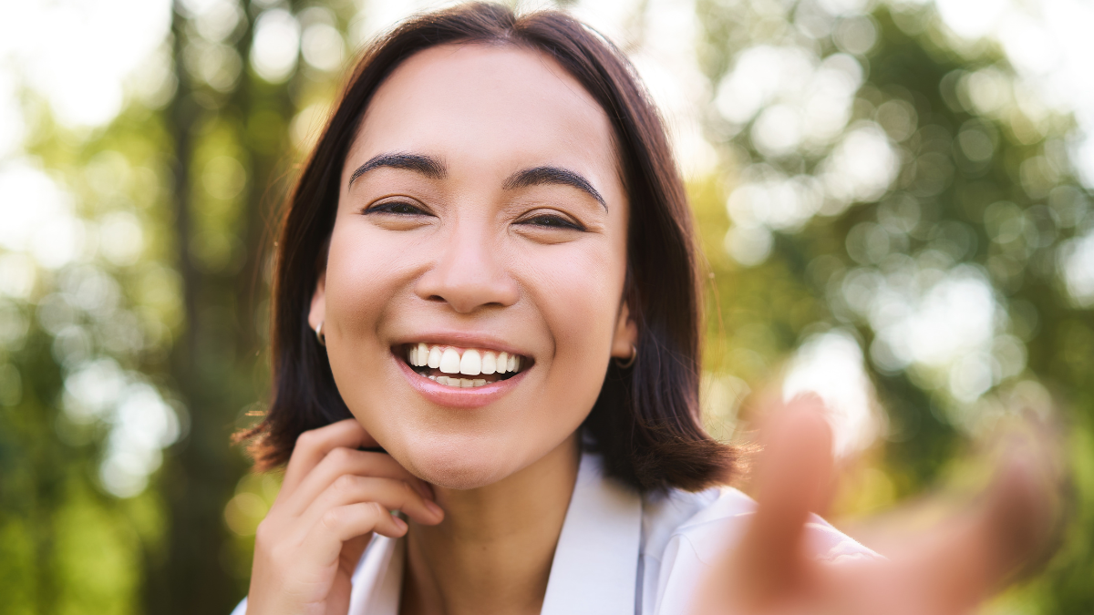 Genuine people. Portrait of asian woman laughing and smiling, walking in park, feeling joy and positivity.