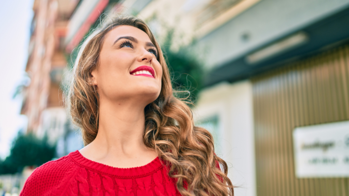Young blonde girl smiling happy walking at the city.