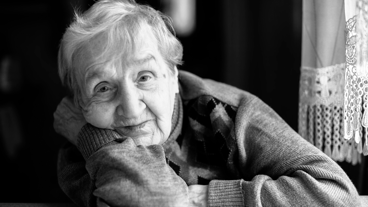 Black and white closeup portrait of an elderly woman.