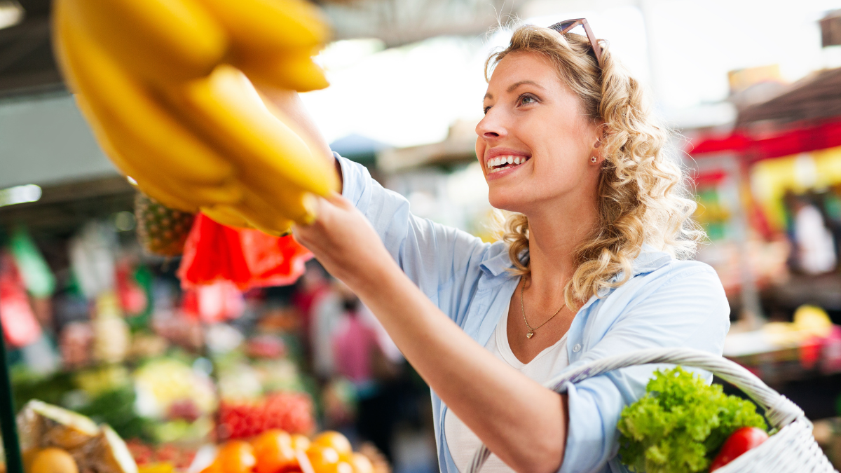 Beautiful women shopping vegetables and fruits on the market. hacks to save money grocery shopping.