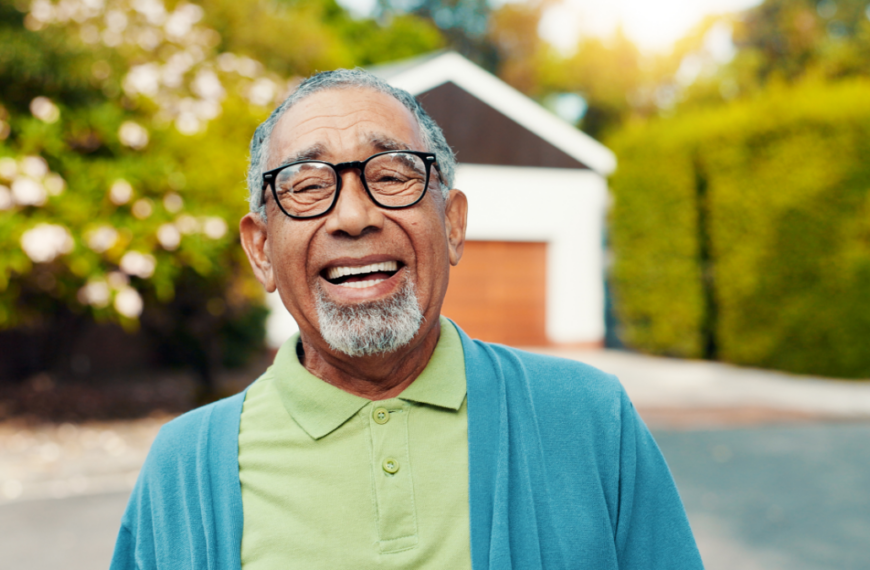 Portrait, outdoor and senior man at retirement home with laughing, happiness and relax on weekend. Smile, funny and elderly male person from Mexico with glasses in backyard of nursing facility.