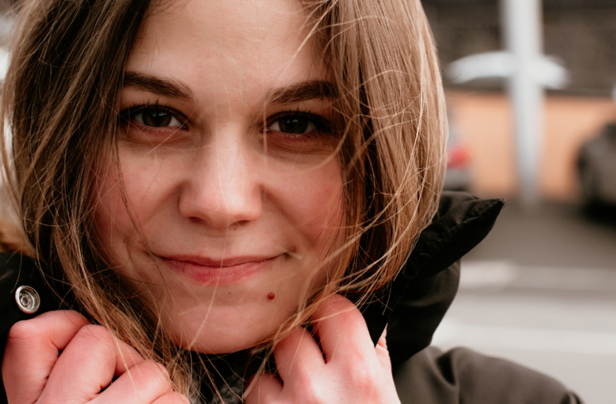 close up portrait of smiling beautiful young woman. street photography.