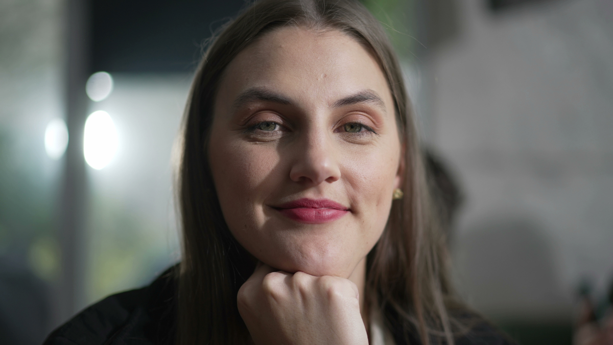 Portrait of a positive young woman smiling at camera. closeup person face. Happy girl in her 20s.