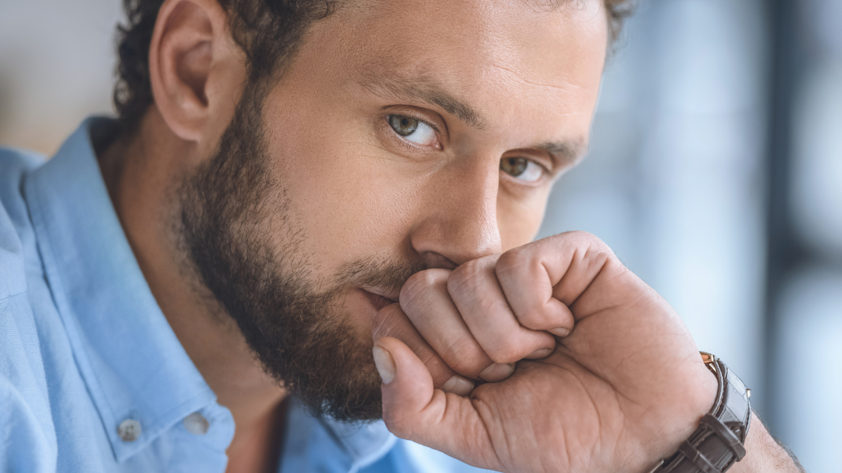 portrait of pensive handsome caucasian man looking at camera.