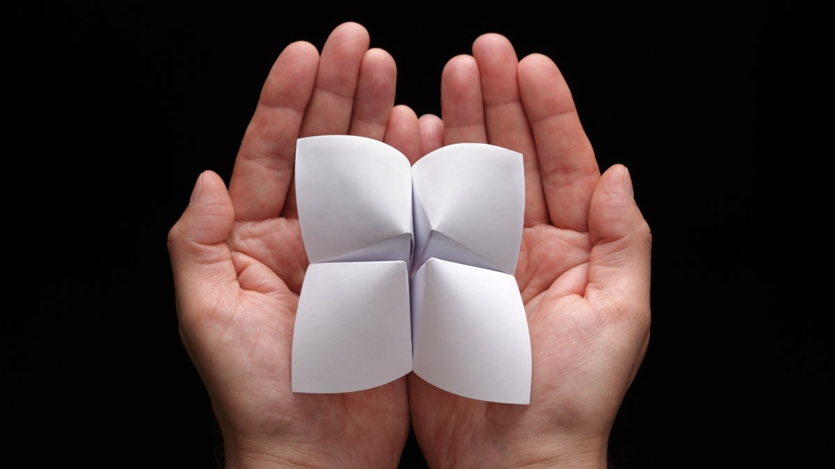 Origami fortune teller with blank choices in cupped hands is a grandma hobby.