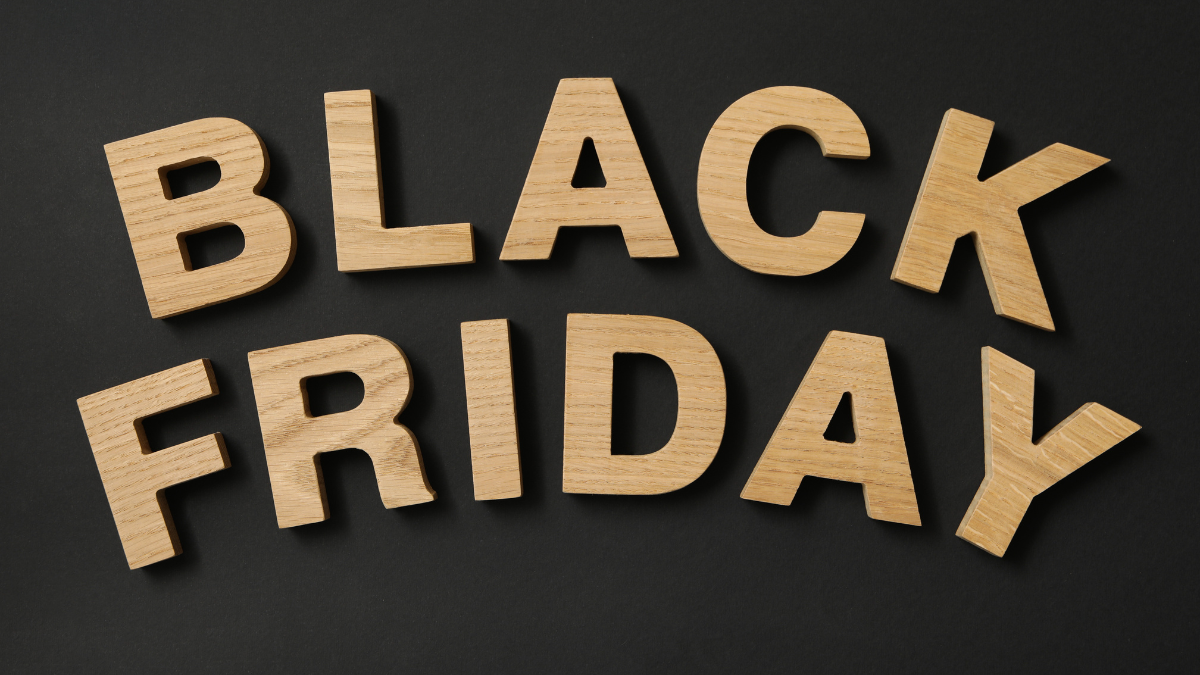 Text Black Friday made of wooden letters on black background.