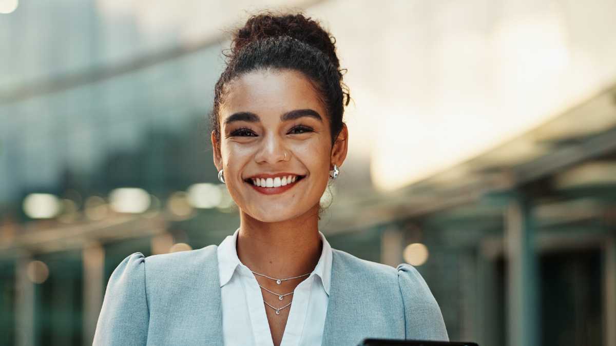 Business, woman and happy portrait in city, outside and confident or smiling with tablet. Corporate career, employees and company pride with technology, social networking and professional review.