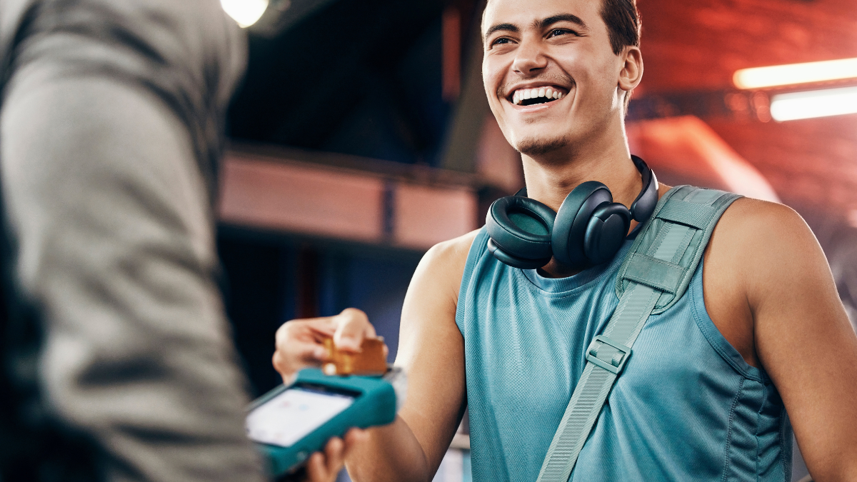 Credit card, payment or customer happy with machine for 5g network, customer service or digital sale in gym. Membership discount, fintech or man with employee for support, help or RFID tech in studio.