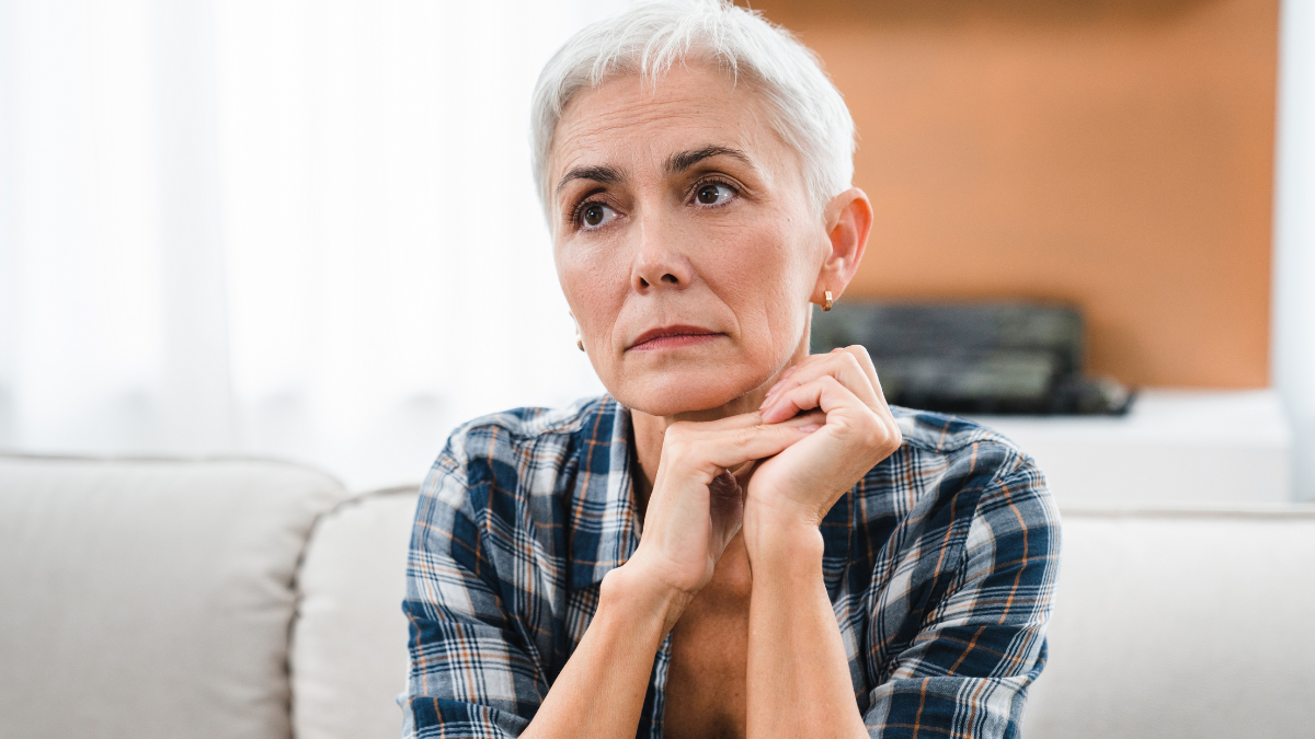 Thoughtful Caucasian middle-aged woman suffering from mental issues, problems at home. Depressed sad mature woman having problems, illness, health issues.